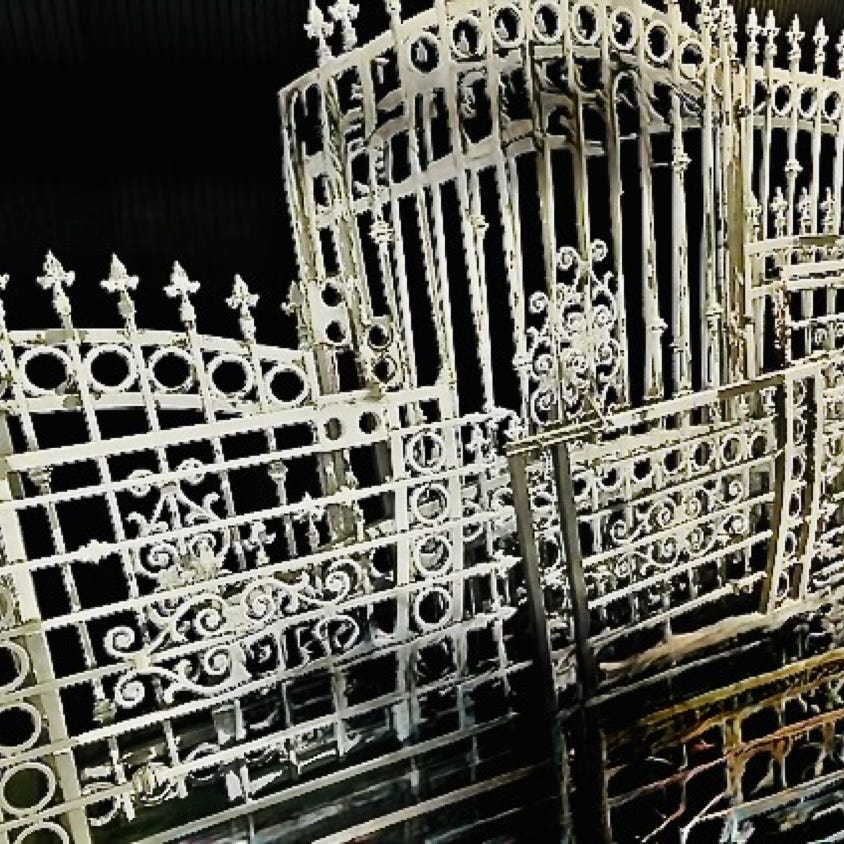 Close-up of barbed wire fence indoors, emphasizing security and metal structure.